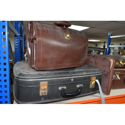 517 - A GROUP OF SUITCASES AND BRIEFCASES, to include a small brown vintage suitcase, width 50cm x height ... 