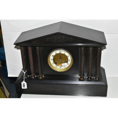 592 - A BLACK SLATE CASED MANTEL CLOCK, of architectural form, the dial bearing Arabic numerals, with key ... 