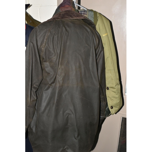 612 - A BROWN BARBOUR CLASSIC BEAUFORT WAX JACKET WITH DETACHABLE HOOD, together with two green quilted Ba... 