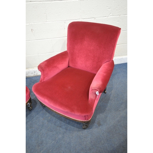 1354 - A PAIR OF EARLY 20TH CENTURY ARMCHAIRS, with maroon upholstery, on turned front legs and brass casto... 