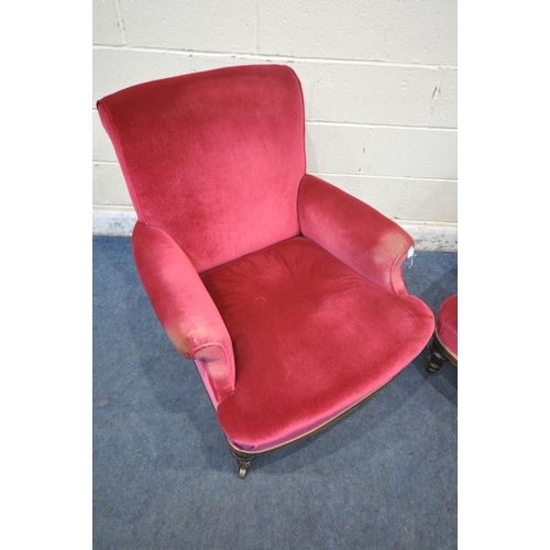 1354 - A PAIR OF EARLY 20TH CENTURY ARMCHAIRS, with maroon upholstery, on turned front legs and brass casto... 