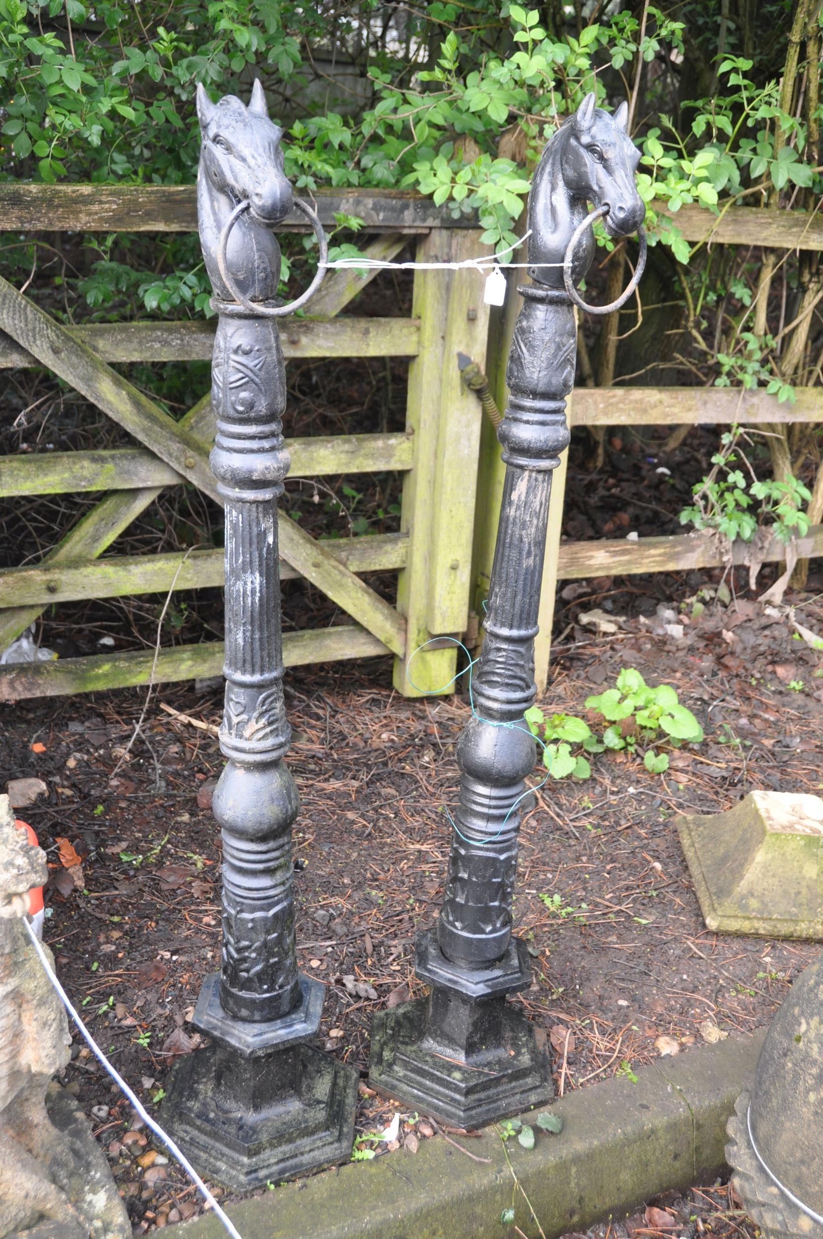 A PAIR OF PAINTED CAST IRON POSTS with what appears to be Celtic ...