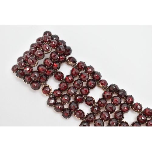 13 - A LATE 19TH CENTURY BOHEMIAN GARNET BRACELET, designed as rectangular faceted garnet set panels, to ... 