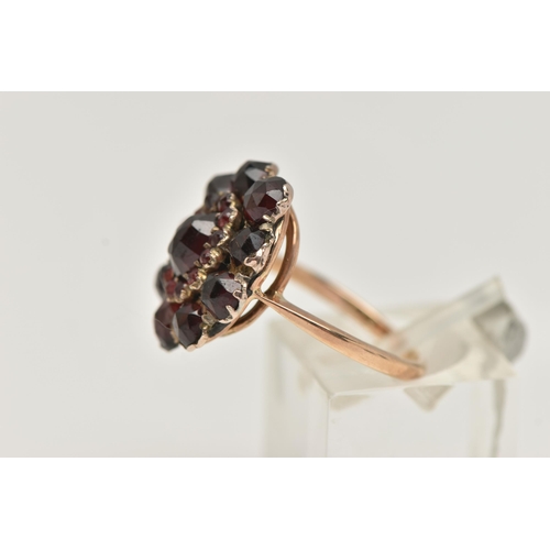 15 - A GARNET CLUSTER RING, the early 20th century cluster set with faceted garnets, to the later mid 20t... 