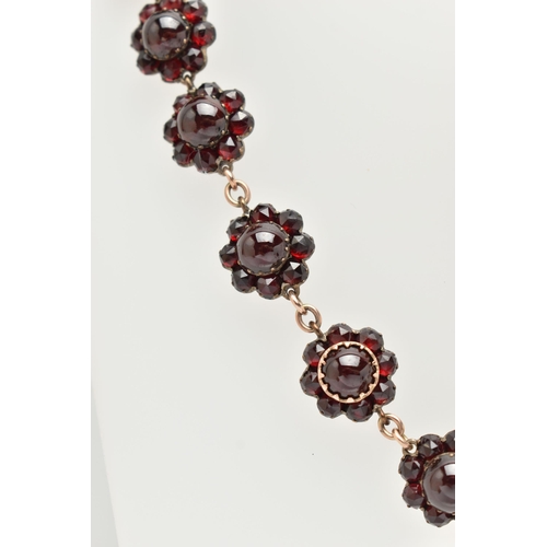 21 - A LATE 19TH CENTURY GARNET NECKLACE, the silver gilt necklace designed as a central circular garnet ... 