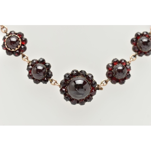 21 - A LATE 19TH CENTURY GARNET NECKLACE, the silver gilt necklace designed as a central circular garnet ... 