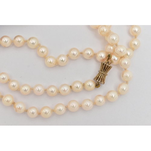 22 - A LONG CULTURED PEARL NECKLACE, the uniform necklace with pinch waist, gold plated, push piece clasp... 