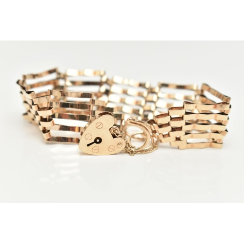 23 - A 9CT GOLD GATE BRACELET, five bar bracelet, approximate width 15.8mm, fitted with a heart padlock c... 