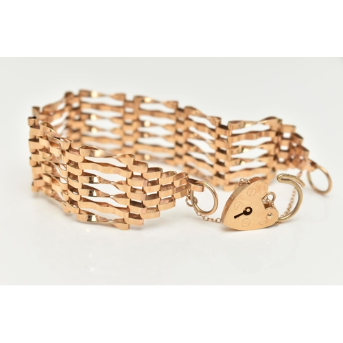 24 - A 9CT GOLD GATE BRACELET, six bar bracelet, approximate width 19.5mm, fitted with a heart padlock cl... 