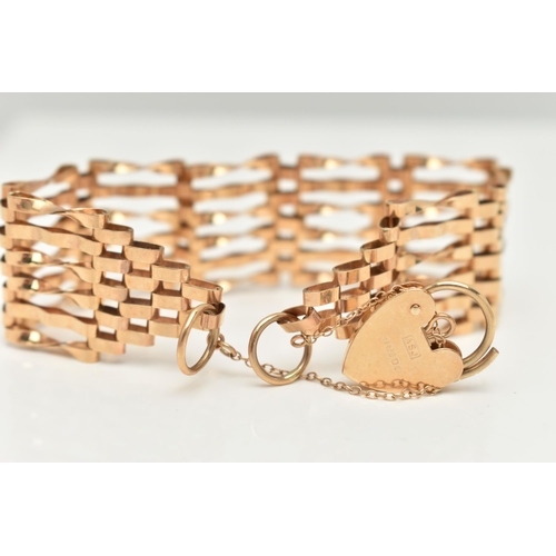 24 - A 9CT GOLD GATE BRACELET, six bar bracelet, approximate width 19.5mm, fitted with a heart padlock cl... 