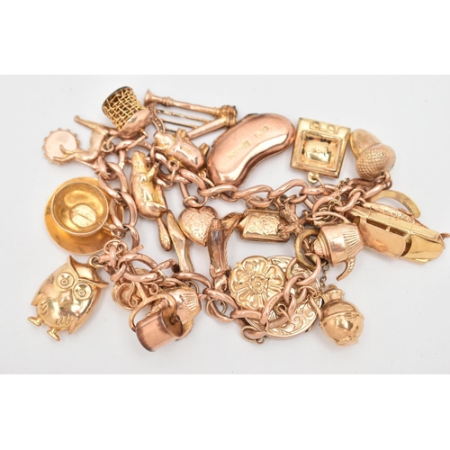 29 - A 9CT GOLD CHARM BRACELET, rose gold curb link bracelet, each link stamped 9.375, fitted with a late... 