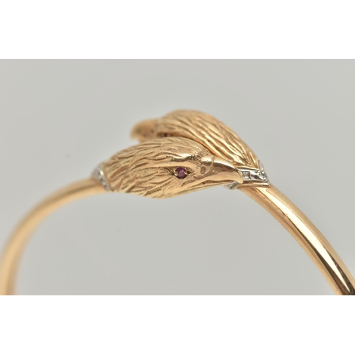 4 - AN EAGLE HEAD CROSSOVER BANGLE, the bangle of crossover slightly sprung design with an eagle head to... 