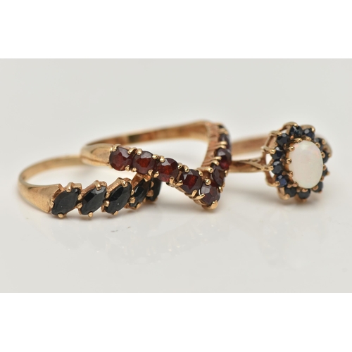 56 - THREE 9CT GOLD GEM SET RINGS, the first a garnet nine stone wishbone ring, hallmarked 9ct Birmingham... 