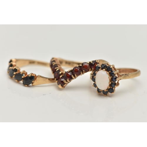 56 - THREE 9CT GOLD GEM SET RINGS, the first a garnet nine stone wishbone ring, hallmarked 9ct Birmingham... 