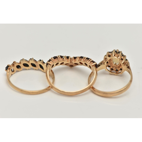 56 - THREE 9CT GOLD GEM SET RINGS, the first a garnet nine stone wishbone ring, hallmarked 9ct Birmingham... 