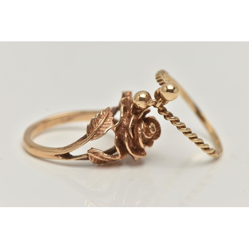 61 - TWO YELLOW METAL RINGS, the first in the form of a textured rose, bifurcated shoulders leading onto ... 