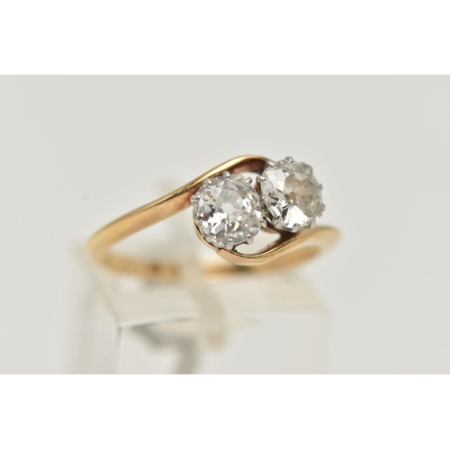 62 - A YELLOW METAL DIAMOND TWO STONE RING, two old  cut diamonds, each in a ten claw white metal setting... 