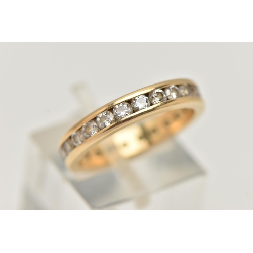 70 - A DIAMOND FULL ETERNITY BAND RING, a yellow metal band ring, channel set with twenty four round bril... 