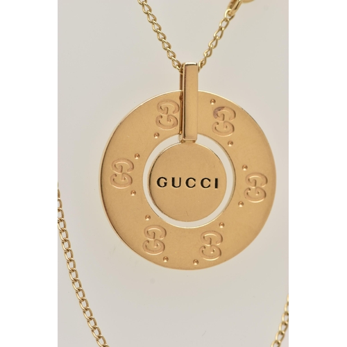 78 - A 'GUCCI' ICON NECKLACE, a yellow metal circular disk pendant with a moveable central disk, approxim... 