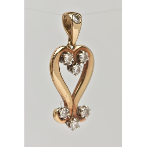 84 - A 9CT GOLD AND DIAMOND PENDANT, designed as an open work heart with scrolling detail, set with seven... 