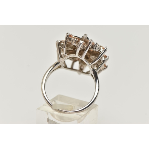 97 - A LARGE WHITE METAL GEM SET DRESS RING, of an oval form, set with marquise cut stones and colourless... 