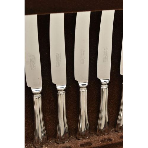 155 - A UNITED CUTLERS OF SHEFFIELD CANTEEN, an incomplete kings pattern cutlery set, encased in a dark wo... 