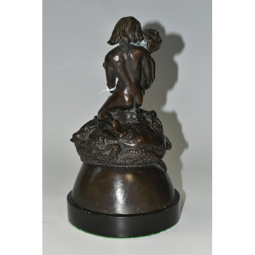 335 - A BRONZE FIGURE GROUP, depicting a mother and child kneeling on top of a mythical beast, loose on a ... 