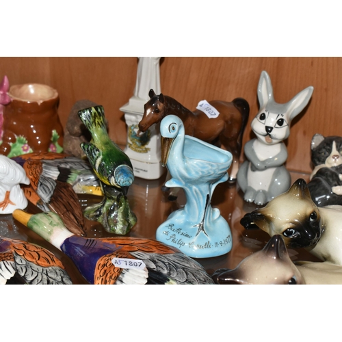 356 - A COLLECTION OF ANIMAL AND BIRD FIGURES, over twenty pieces, to include a Beswick lying down Siamese... 