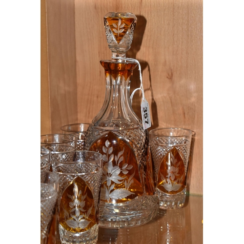 357 - A CONTINENTAL AMBER CUT TO CLEAR DECANTER AND GLASSES, the part set incudes mallet form decanter wit... 