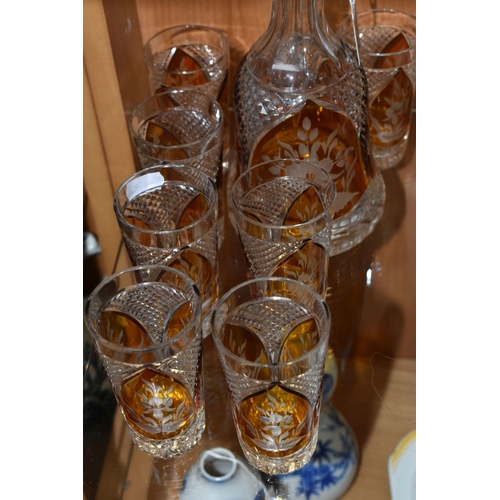 357 - A CONTINENTAL AMBER CUT TO CLEAR DECANTER AND GLASSES, the part set incudes mallet form decanter wit... 