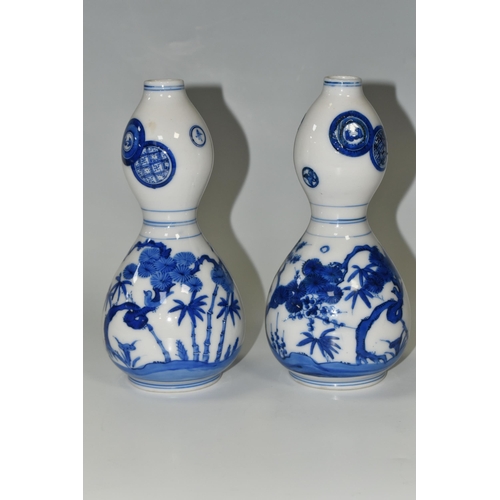 359 - A PAIR OF JAPANESE DOUBLE GOURD VASES, painted in blue with trees and foliage, unmarked, height appr... 