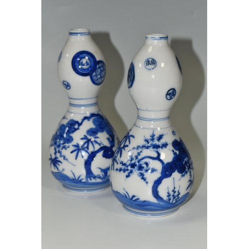 359 - A PAIR OF JAPANESE DOUBLE GOURD VASES, painted in blue with trees and foliage, unmarked, height appr... 