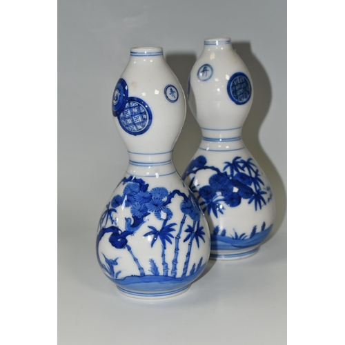 359 - A PAIR OF JAPANESE DOUBLE GOURD VASES, painted in blue with trees and foliage, unmarked, height appr... 