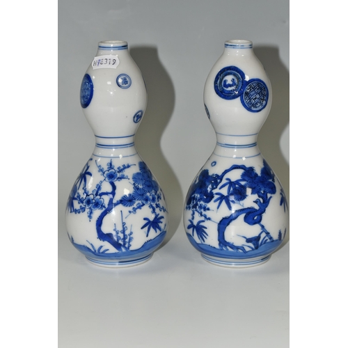 359 - A PAIR OF JAPANESE DOUBLE GOURD VASES, painted in blue with trees and foliage, unmarked, height appr... 