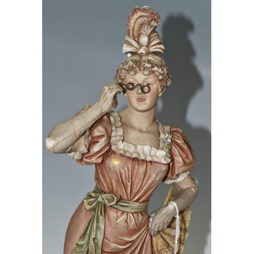 420 - A ROYAL DUX PORCELAIN FIGURE OF A YOUNG WOMAN WITH SPECTACLES/LORGNETTES, applied pink Royal Dux tri... 