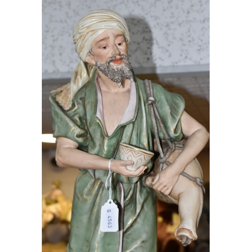 431 - A ROYAL DUX SCULPTURE OF A WATER CARRIER, the male figure carries an animal skin container across hi... 