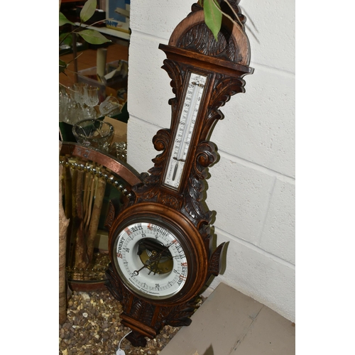 525 - AN OAK BAROMETER AND A COPPER FRAMED MIRROR, comprising a carved banjo barometer with thermometer on... 