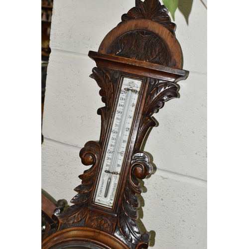 525 - AN OAK BAROMETER AND A COPPER FRAMED MIRROR, comprising a carved banjo barometer with thermometer on... 