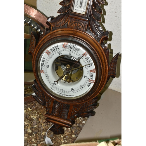 525 - AN OAK BAROMETER AND A COPPER FRAMED MIRROR, comprising a carved banjo barometer with thermometer on... 