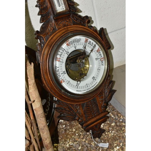 525 - AN OAK BAROMETER AND A COPPER FRAMED MIRROR, comprising a carved banjo barometer with thermometer on... 