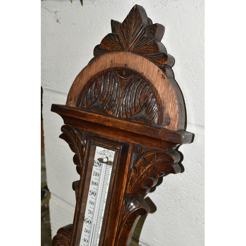 525 - AN OAK BAROMETER AND A COPPER FRAMED MIRROR, comprising a carved banjo barometer with thermometer on... 