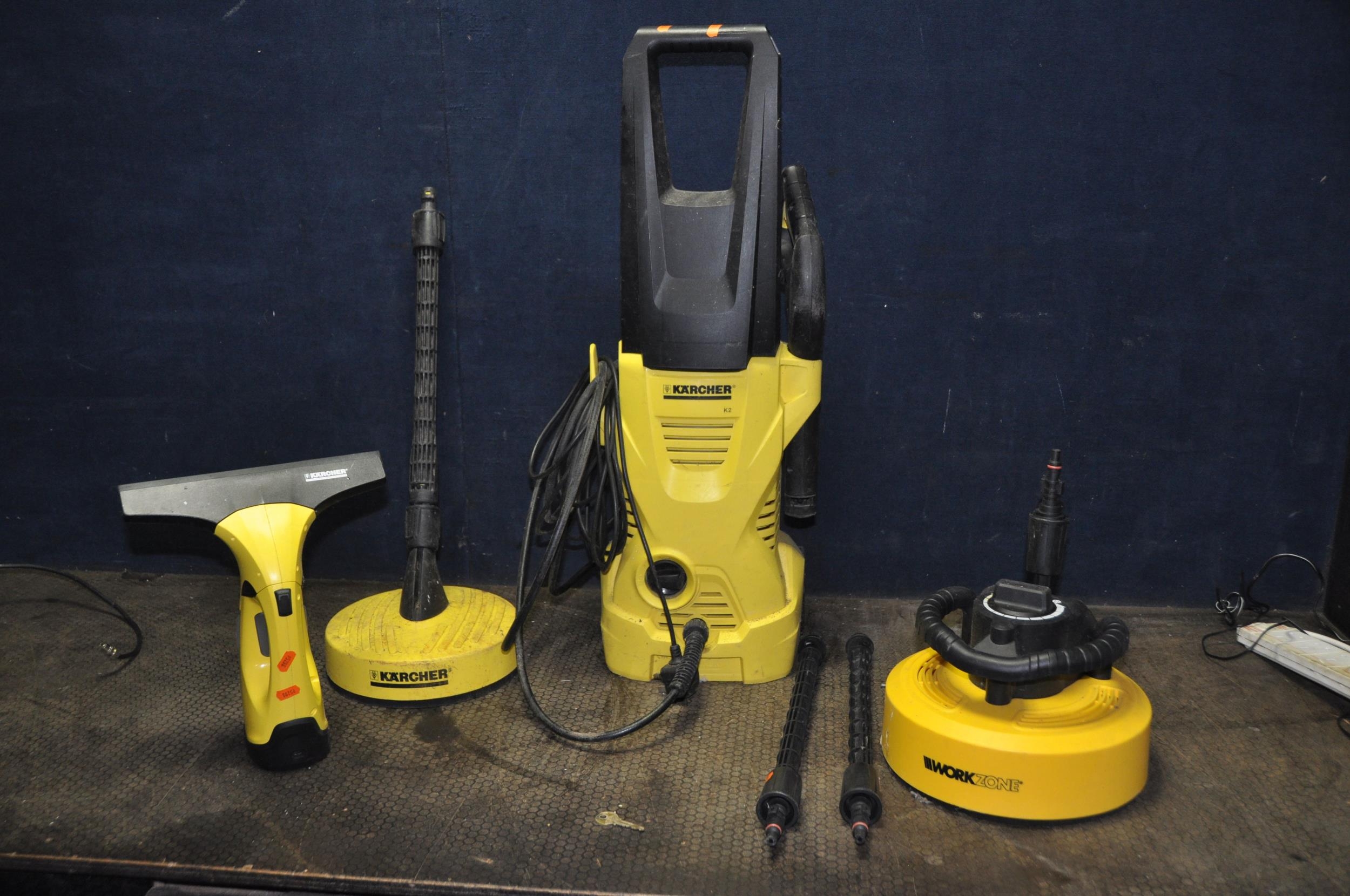 A KARCHER K2 PRESSURE WASHER with lance, two attachment, patio
