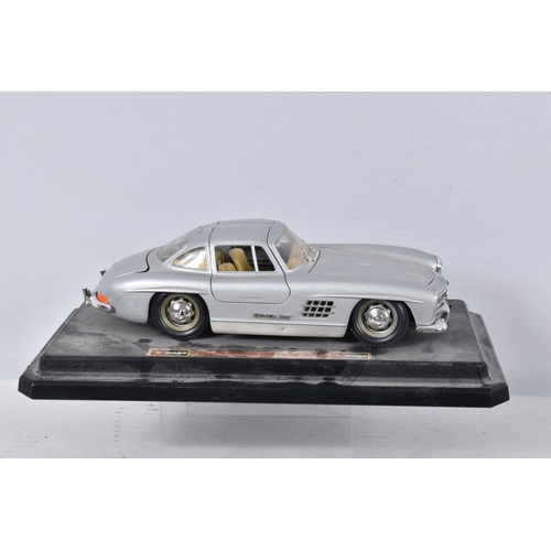 122 - FIVE BOXED AND FOUR LOOSE MODEL VEHICLES,  boxed models include a 1:18 scale Maisto Aston Martin DB7... 