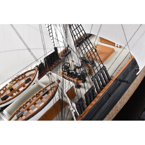 225 - A CONSTRUCTED REVELL PLASTIC KIT OF THE CUTTY SARK HOUSED IN A PERSPEX DISPLAY CASE, kit has been co... 