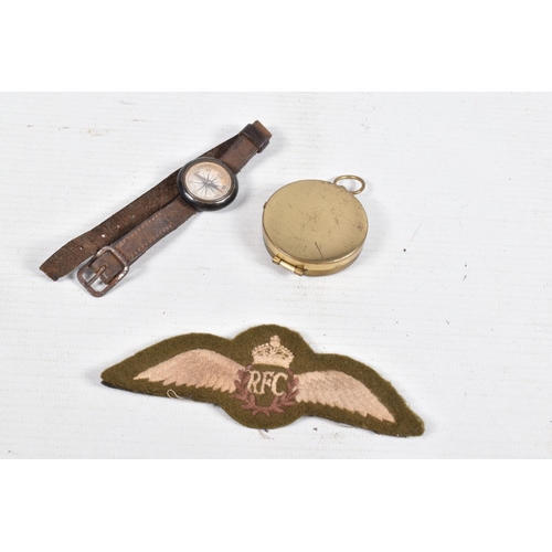 537 - A WWI ERA FLYERS WRIST COMPASS, a pocket compass and a set of RFC cloth wings, the wrist compass com... 