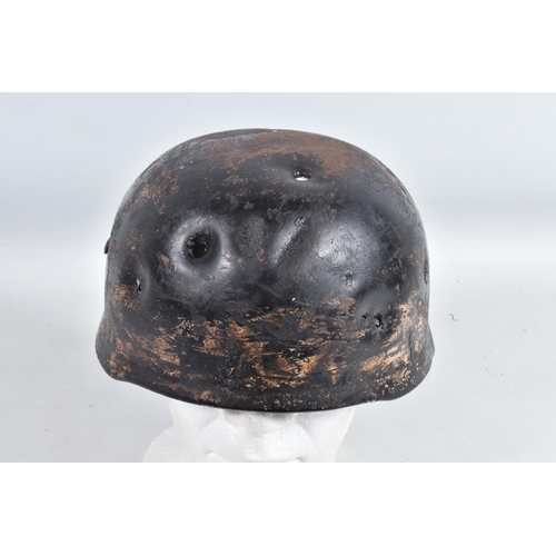 539 - A WWII RELIC OF A GERMAN HELMET, this appears to be a Fallschirmjager or Paratroopers helmet, the ve... 