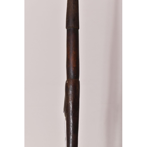 549 - THREE TRIBAL HUNTING SPEARS, the first features a wooden shaft and a grooved arrow shaped steel tip,... 