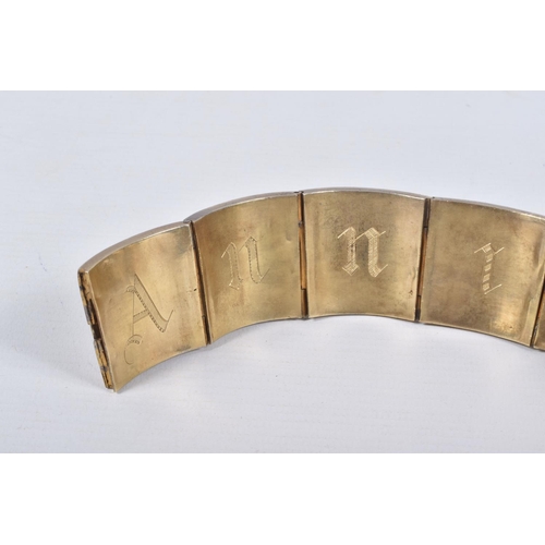 18 - A VICTORIAN GILT BRACELET, comprised of six slightly tapered panels, embossed with an Indian design,... 