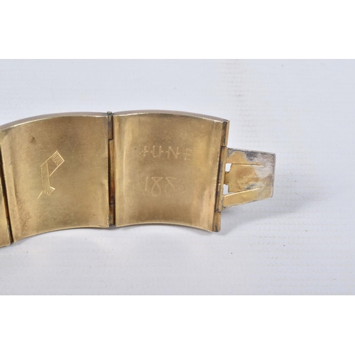 18 - A VICTORIAN GILT BRACELET, comprised of six slightly tapered panels, embossed with an Indian design,... 