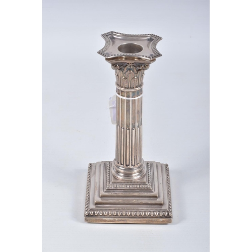 19 - A PAIR OF LATE VICTORIAN SILVER CANDLE STICKS, Corinthian columns scroll leaf detail, on square step... 